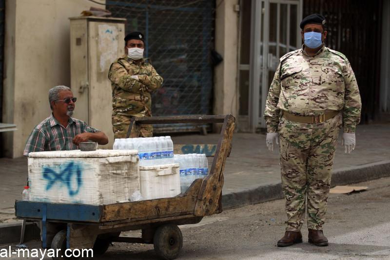 Members of the Iraqi security forces wearing protective masks and gloves stand guard in the capital Baghdad's Tahrir square on May 5.